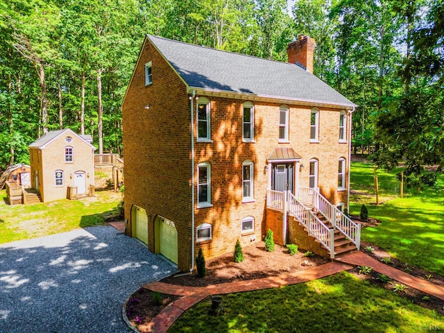 134 Woodmont Ln, Forest, VA 24551 - view of front of house with a chimney, driveway, a garage, brick siding, and a shingled roof