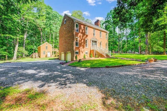 134 Woodmont Ln, Forest, VA 24551 - view of front facade with an attached garage, a chimney, stairs, a front yard, and driveway