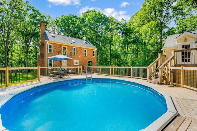 134 Woodmont Ln, Forest, VA 24551 - view of pool featuring a deck, view of wooded area, and an outbuilding
