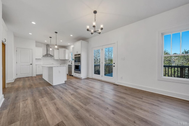 1197 Elk Creek Rd, Forest, VA 24551 - kitchen with wall chimney exhaust hood, a center island, a chandelier, wood finished floors, and recessed lighting