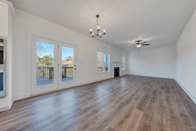1197 Elk Creek Rd, Forest, VA 24551 - unfurnished living room with a fireplace, a chandelier, wood finished floors, a ceiling fan, and baseboards