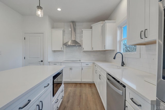 1197 Elk Creek Rd, Forest, VA 24551 - kitchen featuring dishwasher, wall chimney range hood, black electric stovetop, white cabinetry, and light countertops