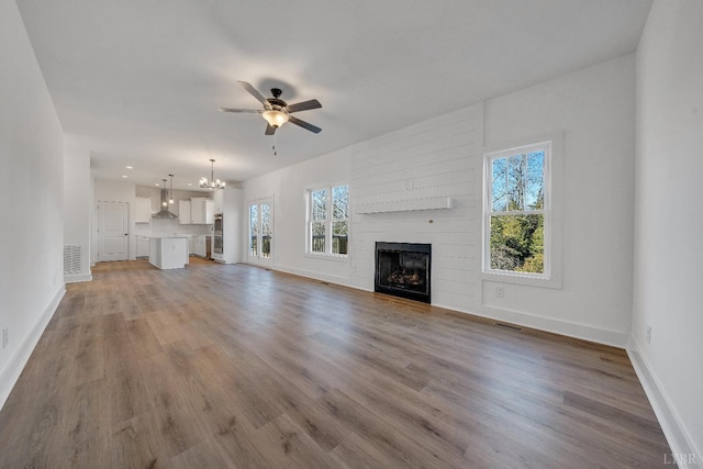 1197 Elk Creek Rd, Forest, VA 24551 - unfurnished living room with a ceiling fan, baseboards, a chandelier, and wood finished floors