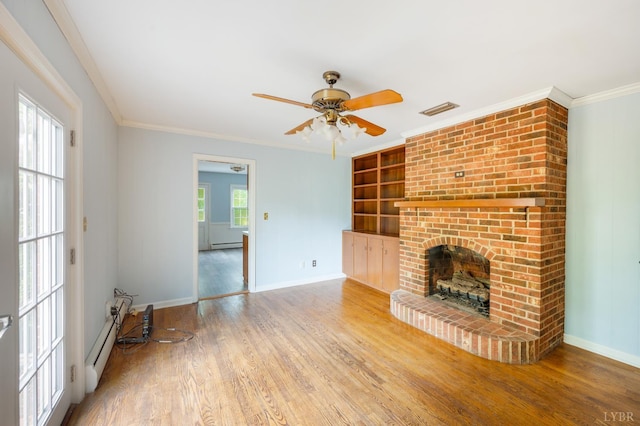 5822 Apache Ln, Lynchburg, VA 24503 - unfurnished living room featuring wood finished floors, a baseboard heating unit, baseboards, a fireplace, and crown molding
