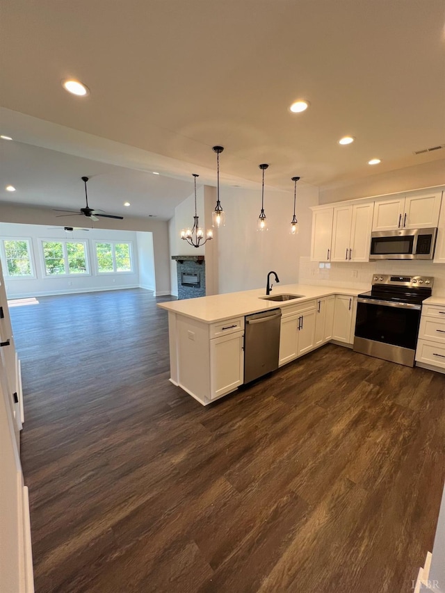 74 Lockridge Ln, Lynchburg, VA 24502 - kitchen featuring appliances with stainless steel finishes, a peninsula, recessed lighting, dark wood-type flooring, and open floor plan