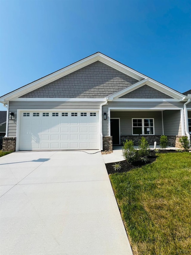 74 Lockridge Ln, Lynchburg, VA 24502 - view of front of home featuring concrete driveway, an attached garage, a front yard, and stone siding