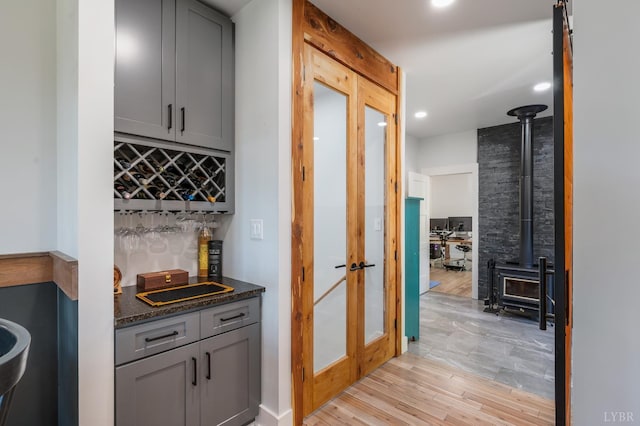 929 Poor House Farm Rd, Amherst, VA 24521 - indoor wet bar featuring a wood stove, recessed lighting, light wood-style flooring, and french doors
