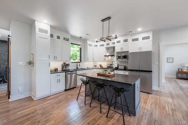 929 Poor House Farm Rd, Amherst, VA 24521 - kitchen with stainless steel appliances, wall chimney range hood, a kitchen breakfast bar, backsplash, and recessed lighting