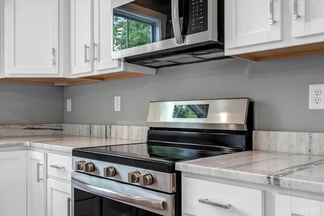 8638 Hat Creek Rd, Brookneal, VA 24528 - kitchen with stainless steel appliances, white cabinetry, and light stone counters