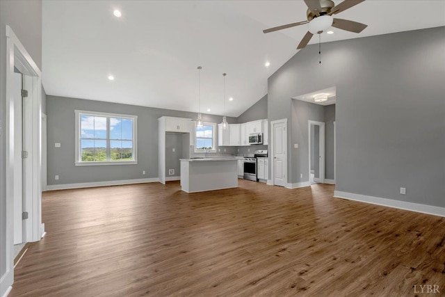 8638 Hat Creek Rd, Brookneal, VA 24528 - unfurnished living room with ceiling fan, high vaulted ceiling, light wood-style floors, and recessed lighting