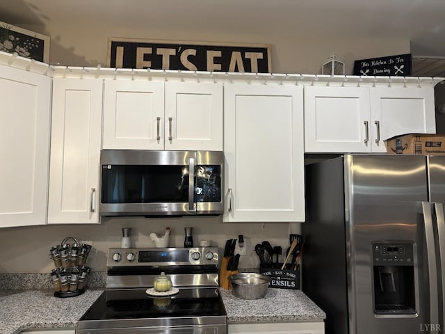 316 E Franklin St, Bedford, VA 24523 - kitchen featuring stainless steel appliances, white cabinetry, and light stone counters