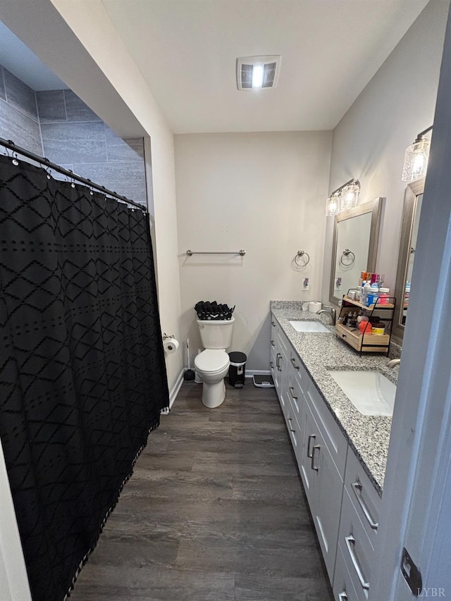 316 E Franklin St, Bedford, VA 24523 - bathroom featuring toilet, wood finished floors, double vanity, a shower with shower curtain, and baseboards