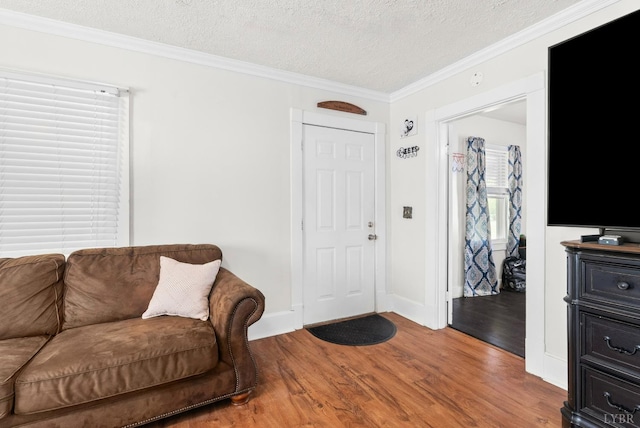 278 Tallyho, Concord, VA 24538 - living room featuring wood finished floors, ornamental molding, a textured ceiling, and baseboards