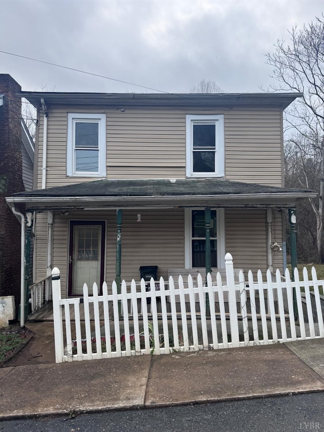 view of front of property with a porch and a fenced front yard
