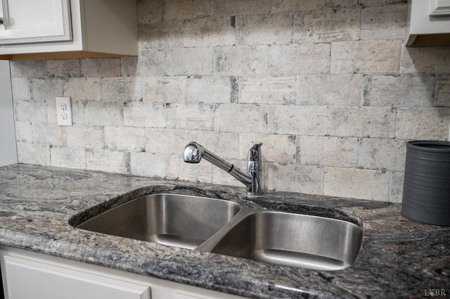 321 Meridian St, Lynchburg, VA 24502 - kitchen view of a sink, dark stone countertops, white cabinetry, and backsplash