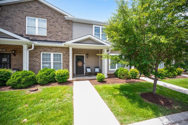 321 Meridian St, Lynchburg, VA 24502 - townhome / multi-family property featuring brick siding, a front lawn, and a porch