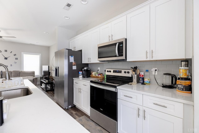 64 Allwell Rd, Lynchburg, VA 24502 - kitchen featuring stainless steel appliances, a sink, dark wood-type flooring, open floor plan, and backsplash