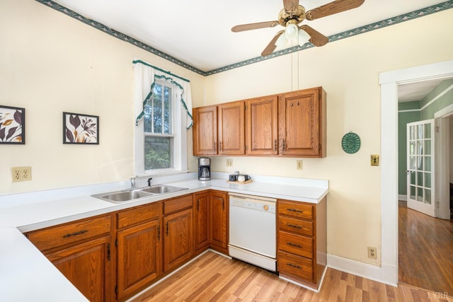 264 N Five Forks Rd, Amherst, VA 24521 - kitchen with white dishwasher, a sink, light wood-style floors, and light countertops