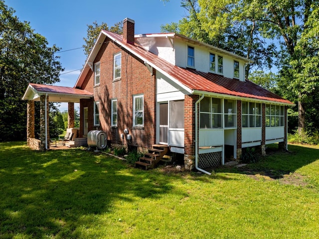 264 N Five Forks Rd, Amherst, VA 24521 - rear view of property featuring a sunroom, a chimney, a yard, and metal roof