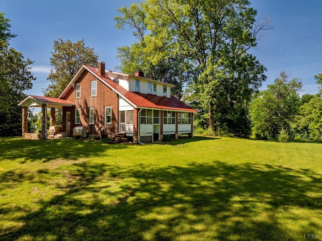 264 N Five Forks Rd, Amherst, VA 24521 - rear view of house with a sunroom, a chimney, a yard, metal roof, and entry steps
