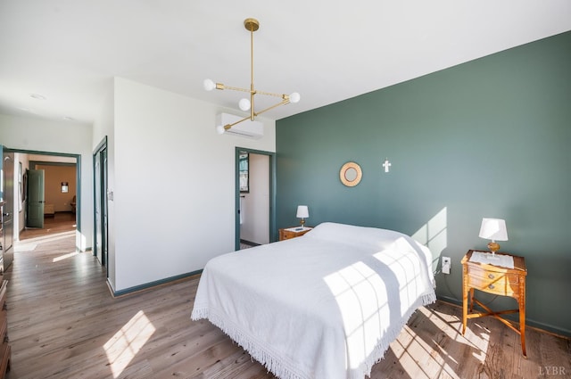 722 Polk St, Lynchburg, VA 24504 - bedroom featuring a chandelier, wood finished floors, a wall mounted air conditioner, and baseboards