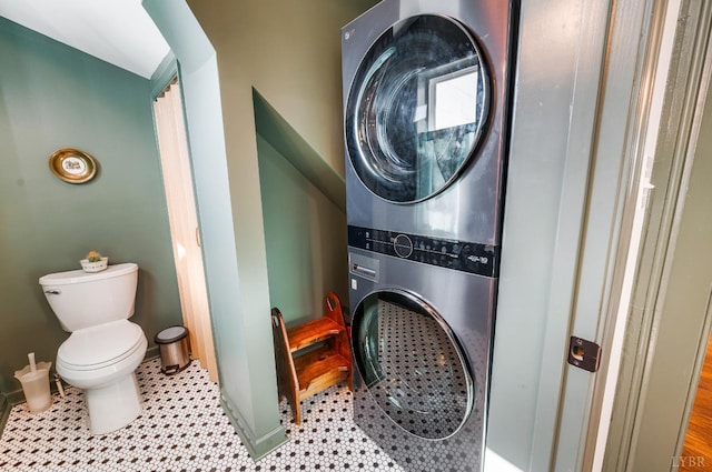 722 Polk St, Lynchburg, VA 24504 - bathroom featuring stacked washing machine and dryer, toilet, and baseboards