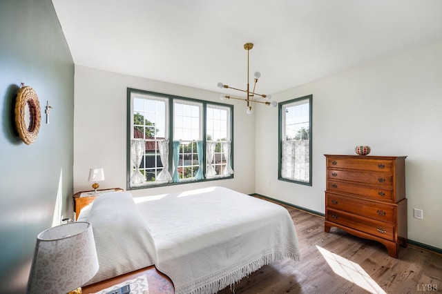 722 Polk St, Lynchburg, VA 24504 - bedroom featuring a chandelier, wood finished floors, and baseboards