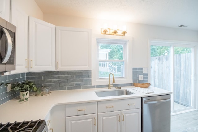 3501 Fort Ave Unit 27, Lynchburg, VA 24501 - kitchen featuring appliances with stainless steel finishes, a sink, healthy amount of natural light, and decorative backsplash