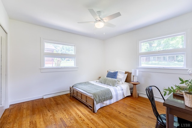 1261 Krise Cir, Lynchburg, VA 24503 - bedroom with a baseboard heating unit, multiple windows, light wood-type flooring, and baseboards