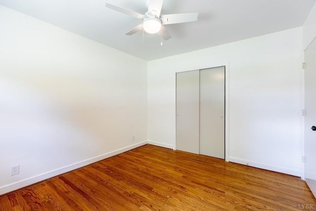 1261 Krise Cir, Lynchburg, VA 24503 - unfurnished bedroom with wood finished floors, baseboards, a closet, and a ceiling fan