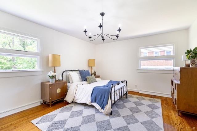 1261 Krise Cir, Lynchburg, VA 24503 - bedroom featuring wood finished floors, a chandelier, baseboard heating, and a baseboard radiator
