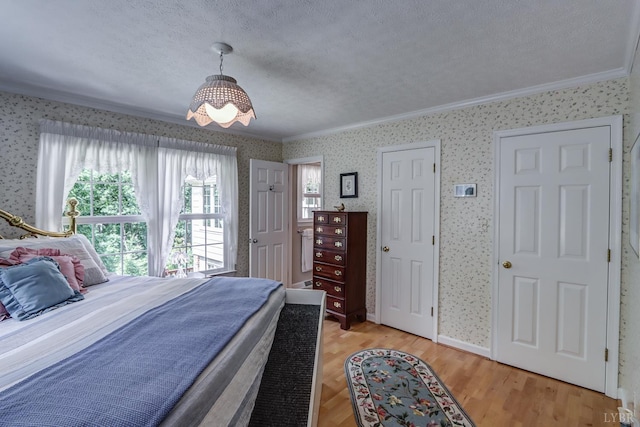 1146 Audubon Dr, Lynchburg, VA 24503 - bedroom with wallpapered walls, crown molding, light wood-style flooring, and a textured ceiling