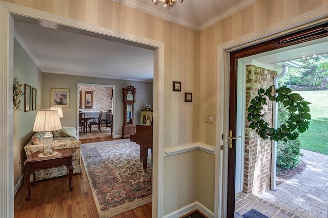 1146 Audubon Dr, Lynchburg, VA 24503 - foyer with ornamental molding, a chandelier, baseboards, wood finished floors, and wallpapered walls
