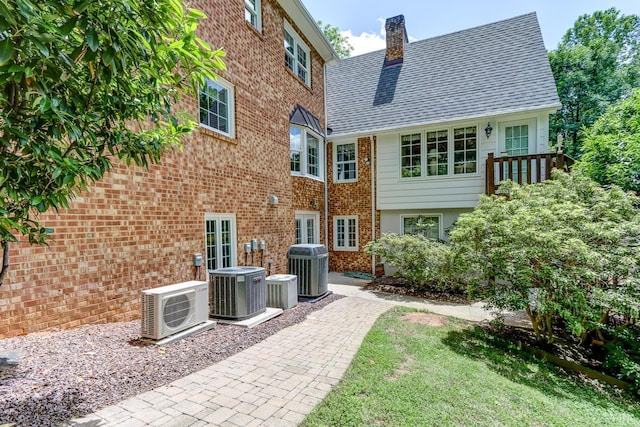 1146 Audubon Dr, Lynchburg, VA 24503 - back of property with a cooling unit, a chimney, central AC unit, and brick siding