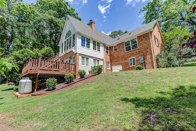 1146 Audubon Dr, Lynchburg, VA 24503 - back of property with a chimney, a deck, a lawn, and brick siding