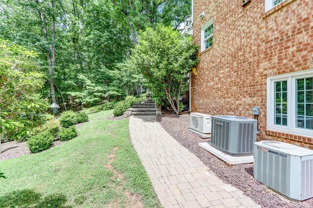 1146 Audubon Dr, Lynchburg, VA 24503 - view of green lawn featuring central AC, stairs, and a cooling unit