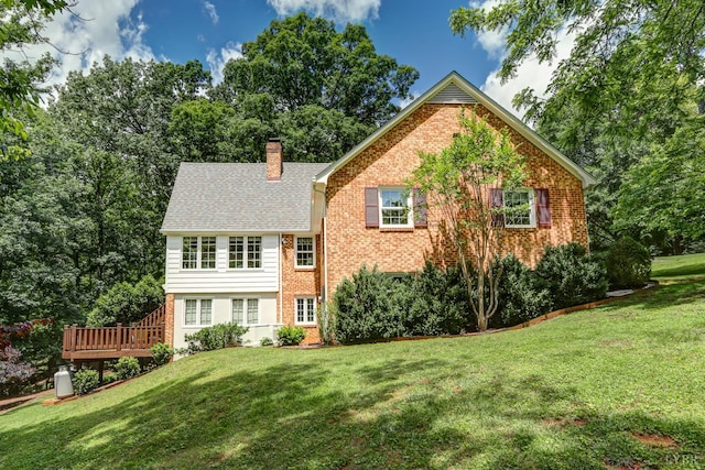 1146 Audubon Dr, Lynchburg, VA 24503 - back of property featuring a chimney, a yard, brick siding, and a wooden deck