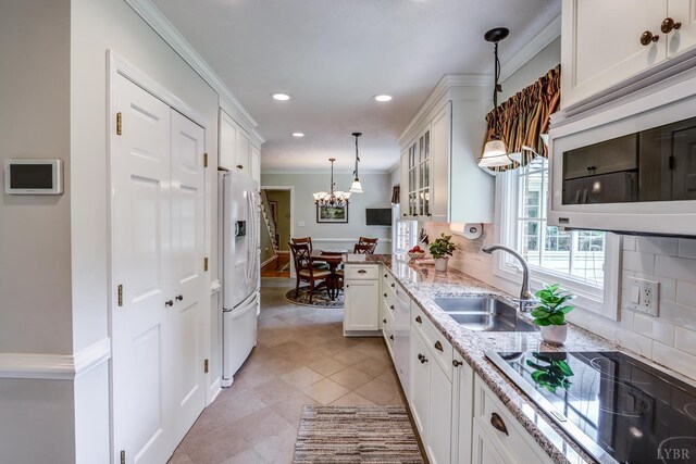 1146 Audubon Dr, Lynchburg, VA 24503 - kitchen featuring a sink, white appliances, white cabinets, ornamental molding, and a chandelier