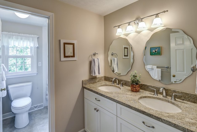 1146 Audubon Dr, Lynchburg, VA 24503 - full bathroom featuring double vanity, toilet, tile patterned flooring, and baseboards
