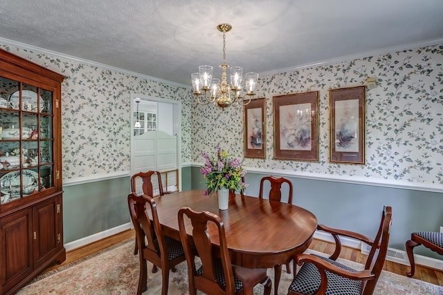 1146 Audubon Dr, Lynchburg, VA 24503 - dining room with wallpapered walls, light wood-style flooring, a chandelier, crown molding, and wainscoting