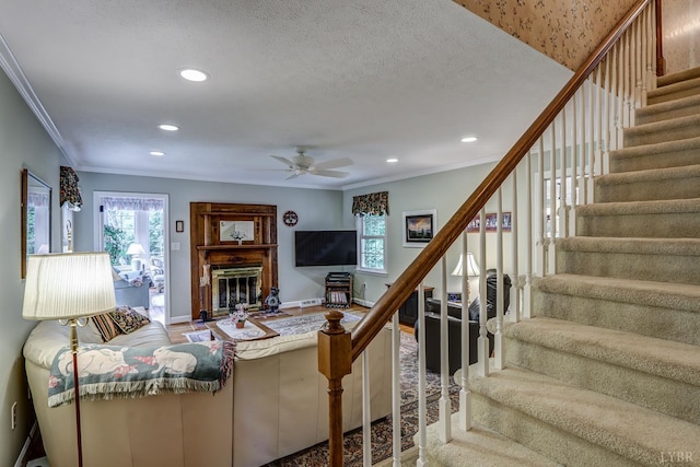 1146 Audubon Dr, Lynchburg, VA 24503 - living room with stairs, recessed lighting, ceiling fan, ornamental molding, and a glass covered fireplace