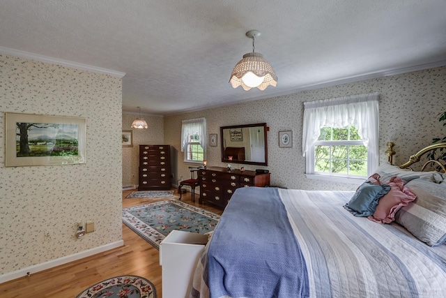 1146 Audubon Dr, Lynchburg, VA 24503 - bedroom featuring ornamental molding, wallpapered walls, wood finished floors, a textured ceiling, and baseboards
