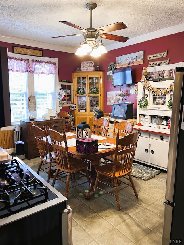 901 Bedford Ave, Altavista, VA 24517 - dining area featuring a textured ceiling, a ceiling fan, crown molding, and light tile patterned floors