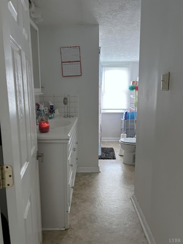 901 Bedford Ave, Altavista, VA 24517 - bathroom with vanity, toilet, baseboards, and concrete flooring