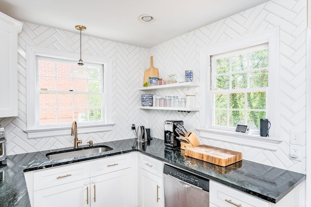 213 Kensington Ave, Lynchburg, VA 24503 - kitchen with stainless steel dishwasher, a sink, white cabinetry, decorative light fixtures, and tasteful backsplash