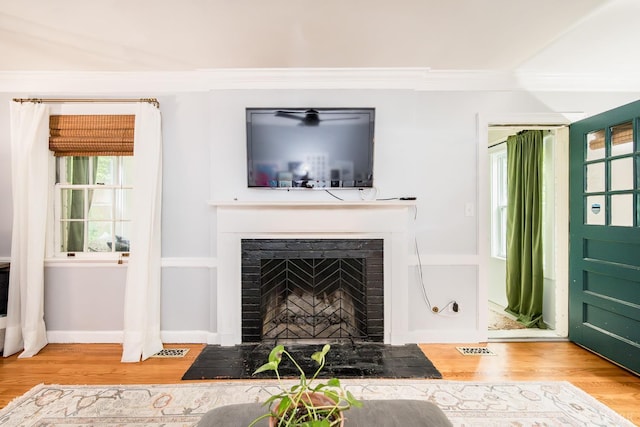 213 Kensington Ave, Lynchburg, VA 24503 - living room with wood finished floors, crown molding, and a fireplace with flush hearth