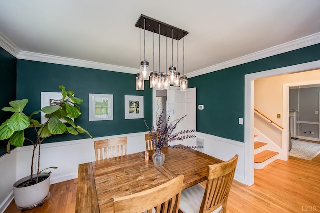 213 Kensington Ave, Lynchburg, VA 24503 - dining space featuring crown molding, stairs, light wood-type flooring, a chandelier, and baseboards