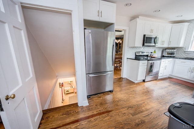 213 Kensington Ave, Lynchburg, VA 24503 - kitchen with appliances with stainless steel finishes, dark countertops, dark wood-type flooring, decorative backsplash, and recessed lighting