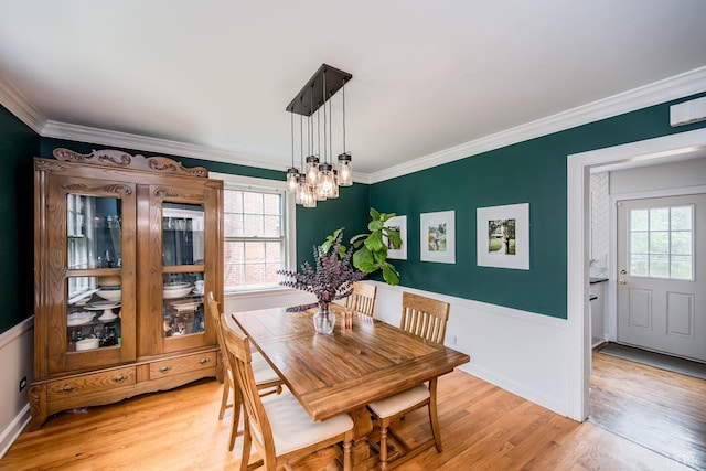 213 Kensington Ave, Lynchburg, VA 24503 - dining area featuring a chandelier, plenty of natural light, crown molding, light wood-type flooring, and a wainscoted wall