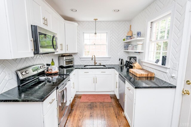213 Kensington Ave, Lynchburg, VA 24503 - kitchen featuring appliances with stainless steel finishes, a sink, white cabinets, and backsplash